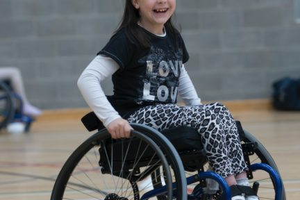 girl in black and white long sleeve shirt sitting on black wheelchair